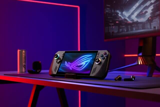 05_gaming setup featuring the ROG Ally X handheld console, positioned on a desk with vibrant LED lighting in the background. The
